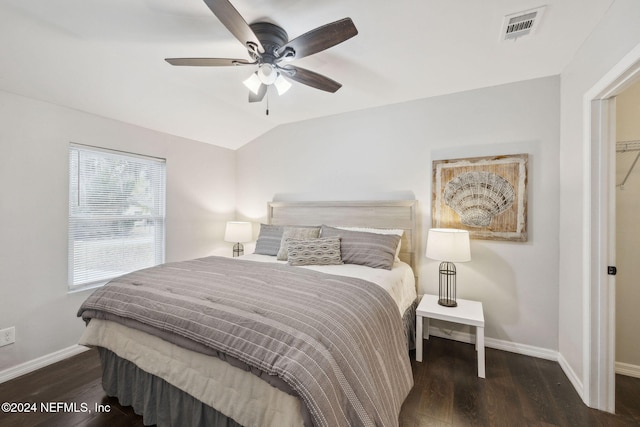 bedroom with ceiling fan, dark hardwood / wood-style floors, and vaulted ceiling