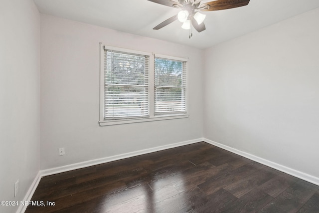 empty room with dark hardwood / wood-style floors and ceiling fan