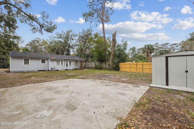 exterior space featuring a patio area and a storage shed