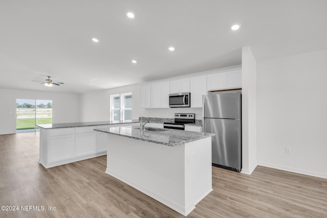 kitchen with white cabinets, sink, an island with sink, and appliances with stainless steel finishes