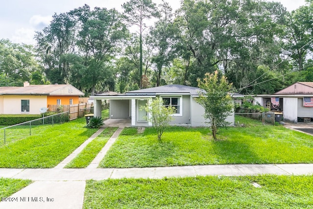 ranch-style house featuring a carport and a front lawn