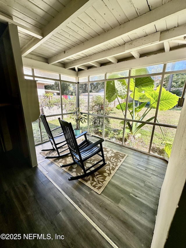 sunroom featuring beamed ceiling