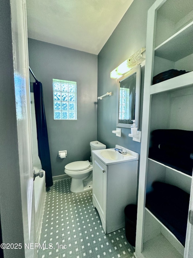 bathroom with vanity, toilet, and curtained shower