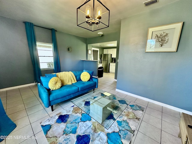 living room with light tile patterned flooring and an inviting chandelier