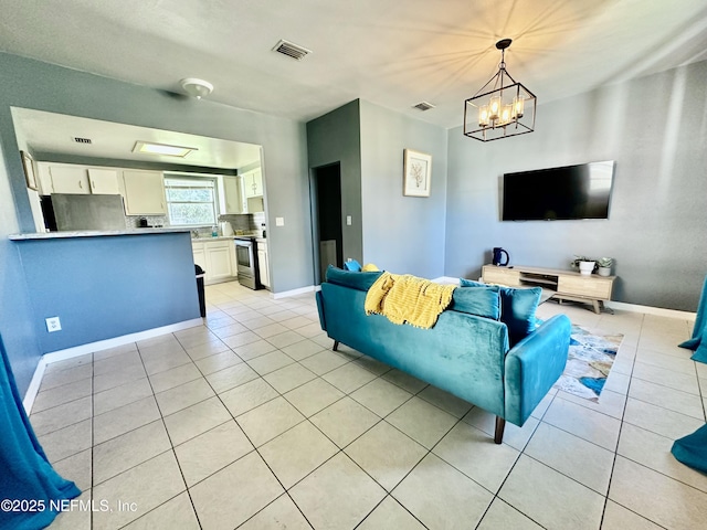 living room featuring light tile patterned floors and a notable chandelier