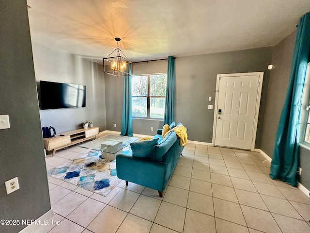 tiled living room with a notable chandelier