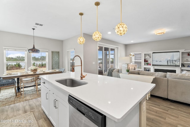 kitchen with sink, stainless steel dishwasher, and hanging light fixtures