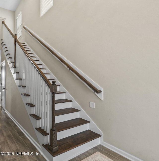 stairs with hardwood / wood-style floors