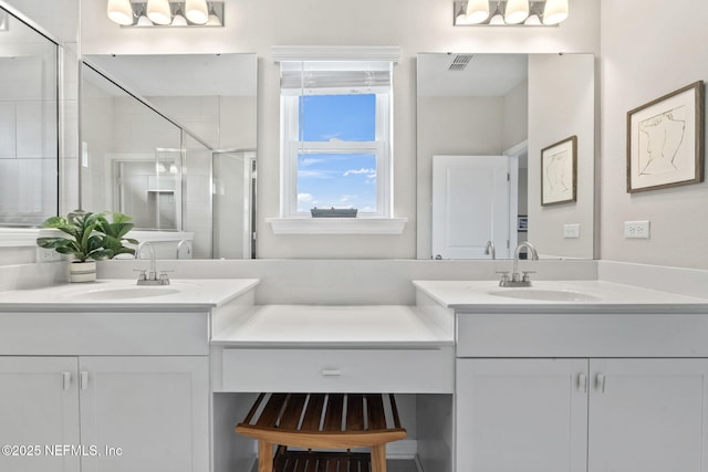 bathroom with vanity and a shower with shower door