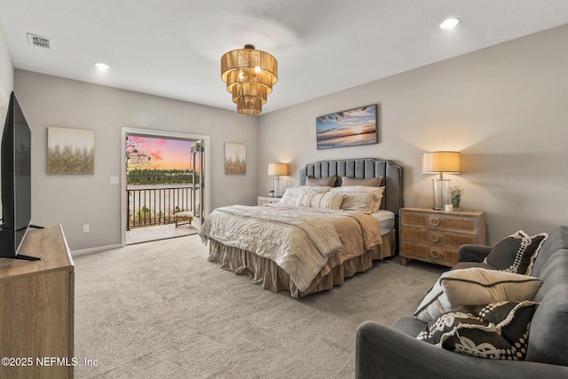 carpeted bedroom with an inviting chandelier and access to outside