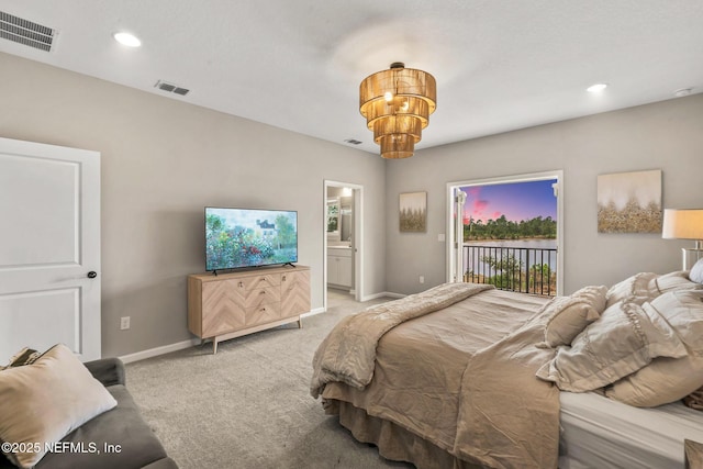 carpeted bedroom with ensuite bathroom, access to outside, and a notable chandelier