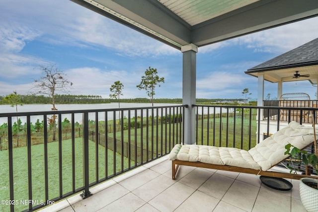 balcony featuring a water view and ceiling fan