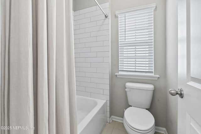 bathroom with shower / tub combo with curtain and toilet