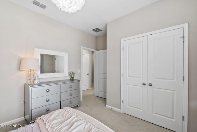 bedroom with light carpet and a closet