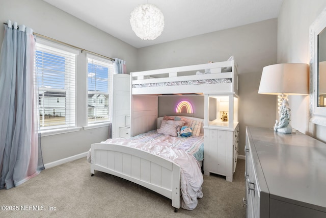 carpeted bedroom featuring a chandelier