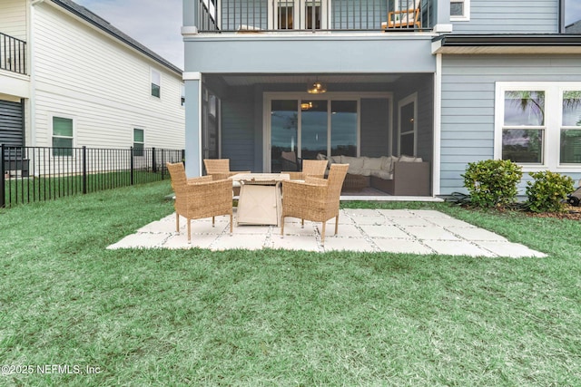 exterior space featuring a patio area, a balcony, and a lawn