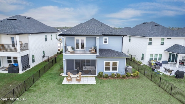 rear view of house featuring a yard, a patio area, a sunroom, and central air condition unit