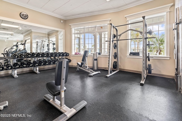 gym featuring crown molding and a wealth of natural light