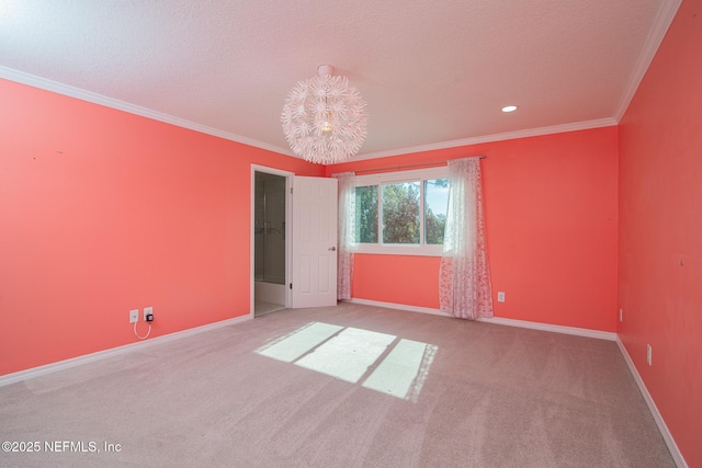 unfurnished room featuring an inviting chandelier, carpet floors, and crown molding