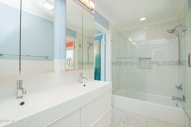 bathroom featuring tile patterned flooring, tiled shower / bath, crown molding, and sink