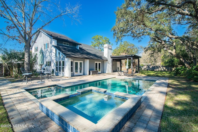 back of house featuring a pool with hot tub, french doors, a gazebo, and a patio