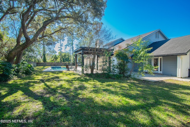 view of yard featuring a fenced in pool, a patio area, and a gazebo