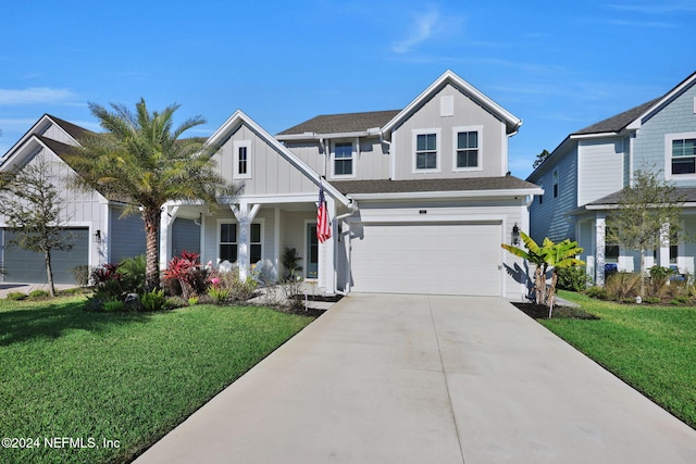 view of front of property featuring a garage and a front lawn