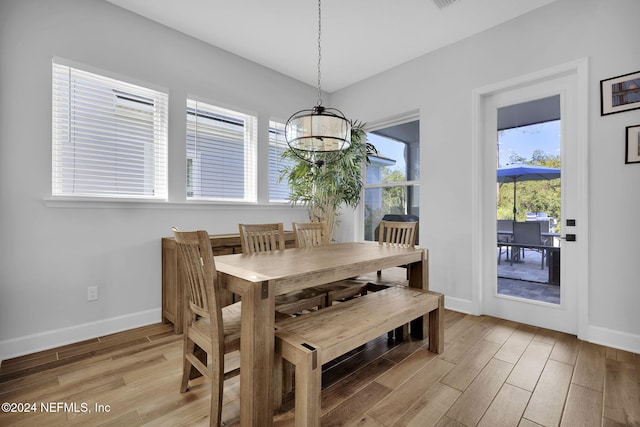 dining area featuring light hardwood / wood-style floors and an inviting chandelier