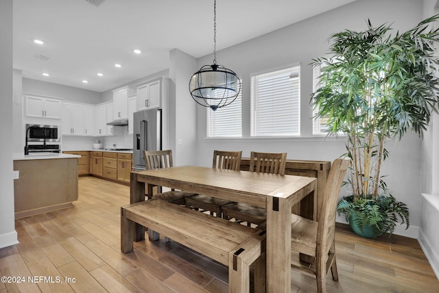 dining space featuring light wood-type flooring