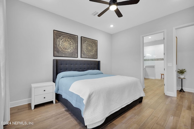 bedroom featuring light hardwood / wood-style flooring, ensuite bath, and ceiling fan