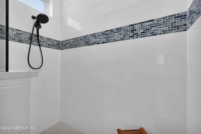 bathroom with tiled shower