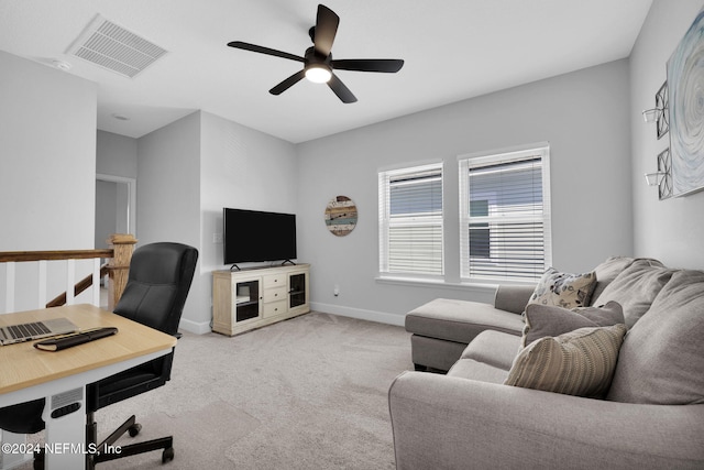 home office featuring ceiling fan and light carpet