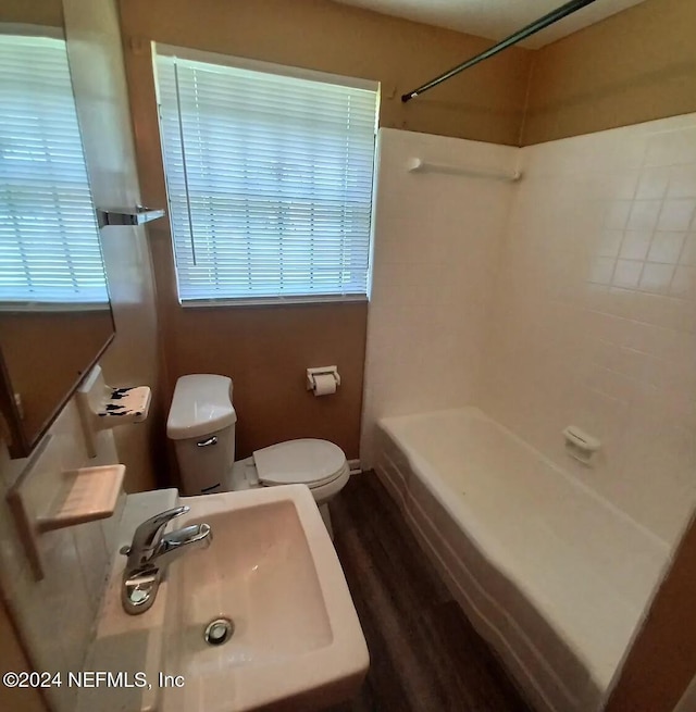 bathroom with toilet, wood-type flooring, and sink