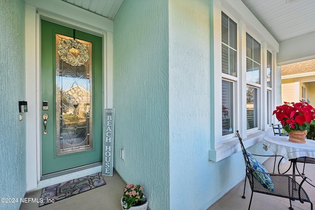 view of exterior entry featuring a porch