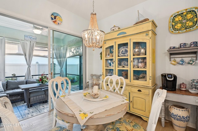 dining area featuring light hardwood / wood-style floors and an inviting chandelier