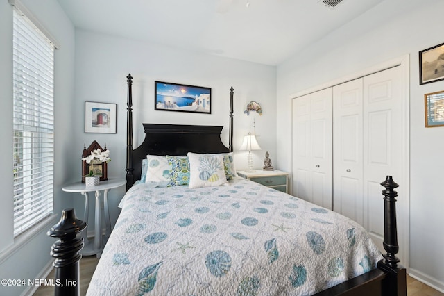 bedroom with wood-type flooring and a closet