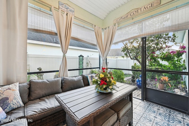 sunroom / solarium featuring lofted ceiling