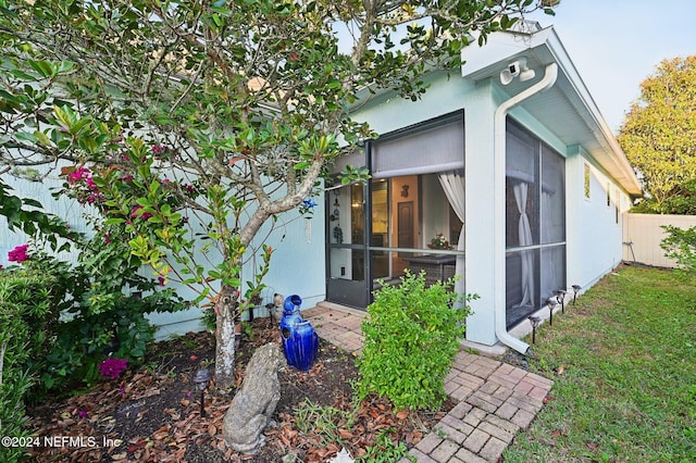 view of side of property featuring a sunroom