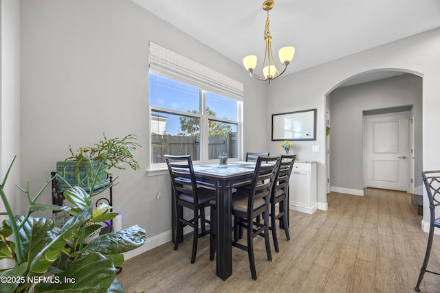 dining room featuring a chandelier and light wood-type flooring