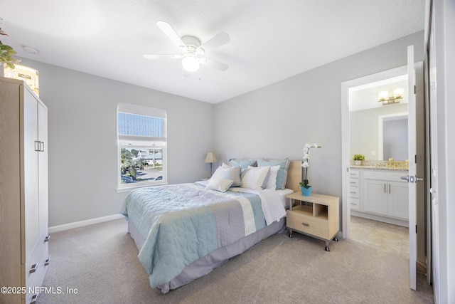 bedroom with light carpet, connected bathroom, ceiling fan, and sink