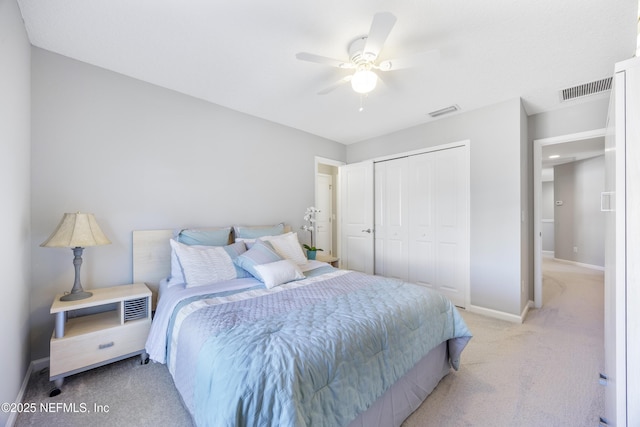 carpeted bedroom featuring ceiling fan and a closet