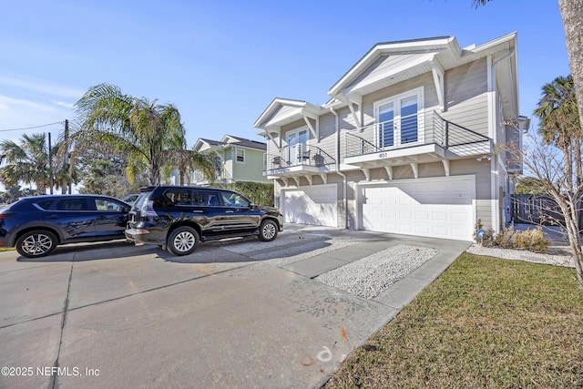 view of front of property featuring a garage and a balcony