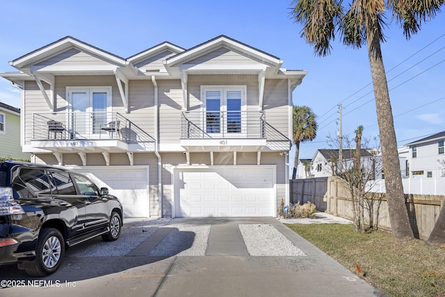 view of front of property featuring a balcony and a garage