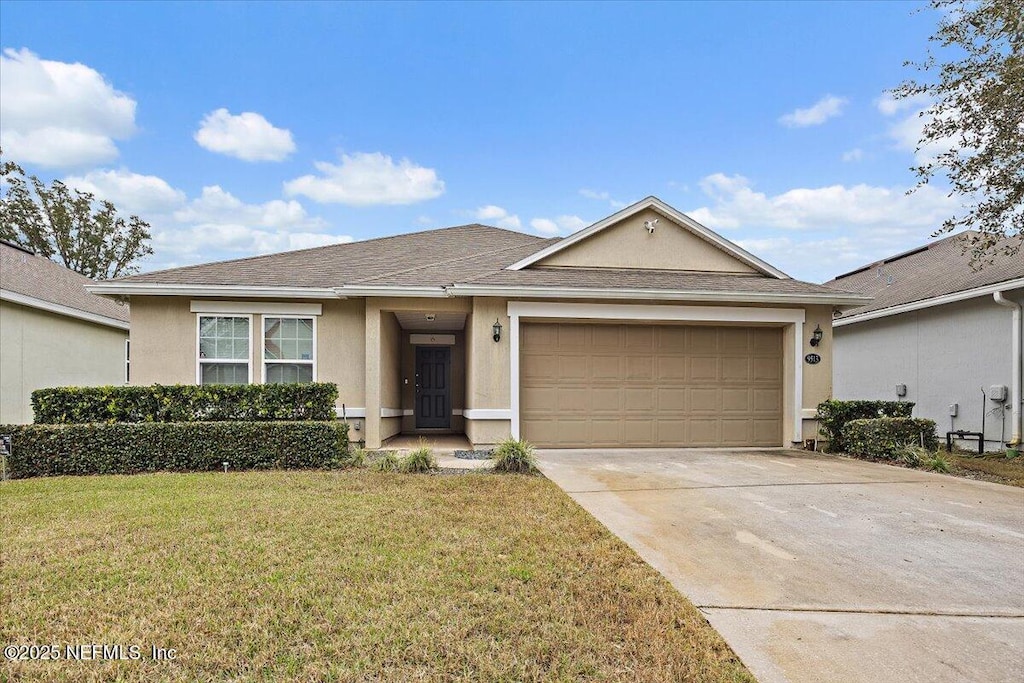 view of front of home with a garage and a front yard