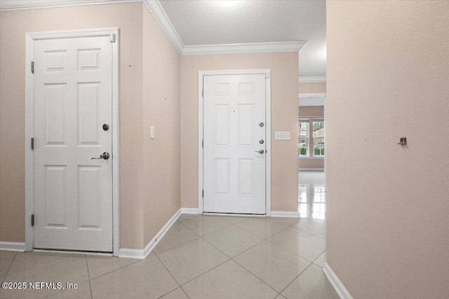 tiled foyer featuring crown molding and a textured ceiling