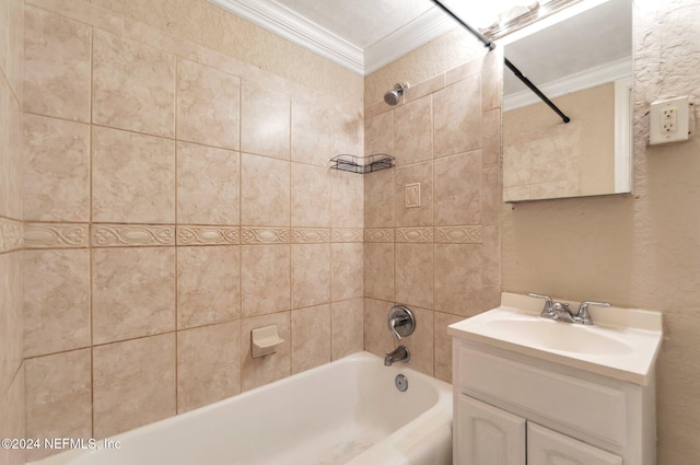 bathroom with tiled shower / bath combo, vanity, and ornamental molding