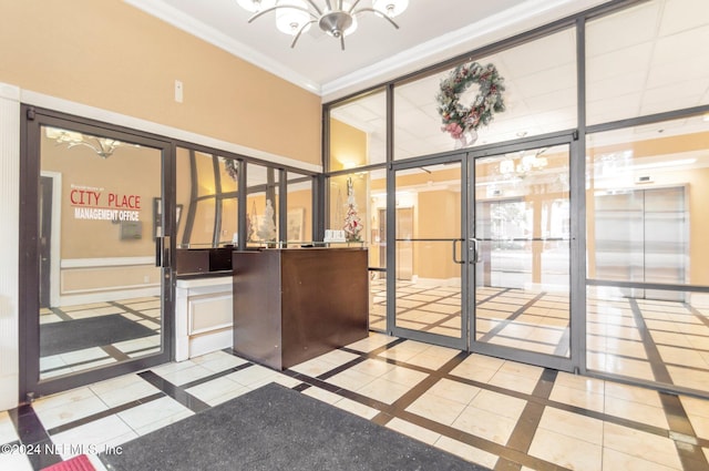 welcome area with french doors and a notable chandelier