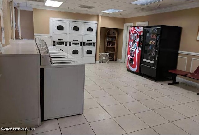 clothes washing area featuring washer and dryer, stacked washer / dryer, and light tile patterned floors