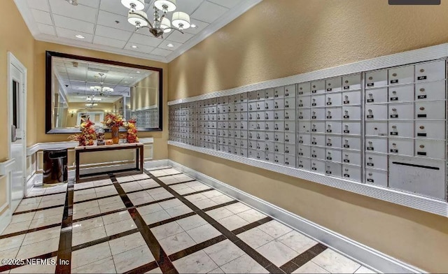 interior space featuring a mail area, a chandelier, and ornamental molding