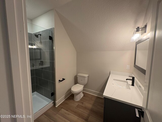 36199 Pitch Ln, Hilliard, FL 32046 - bathroom featuring a textured ceiling, vanity, wood finished floors, a stall shower, and toilet